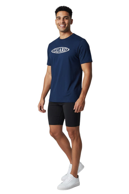 The Lifeguard Store navy blue short sleeve crew neck rashguard with white GUARD logo on chest. Polyester/spandex blend.