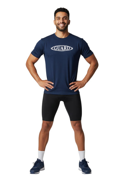 The Lifeguard Store navy blue short sleeve crew neck rashguard with white GUARD logo on chest. Polyester/spandex blend.