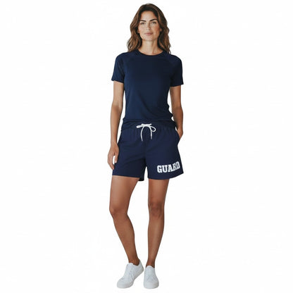 The Lifeguard Store navy blue polyester-spandex blend shorts with white "GUARD" text and drawstring waist.