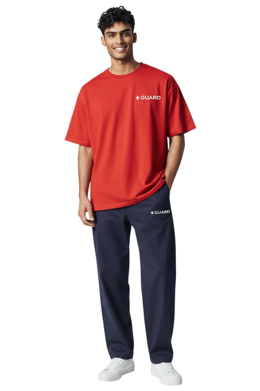 The Lifeguard Store navy blue sweatpants with drawstring and side pockets, featuring a white '+ GUARD' logo on the left thigh. Made of 50% Cotton / 50% Polyester.