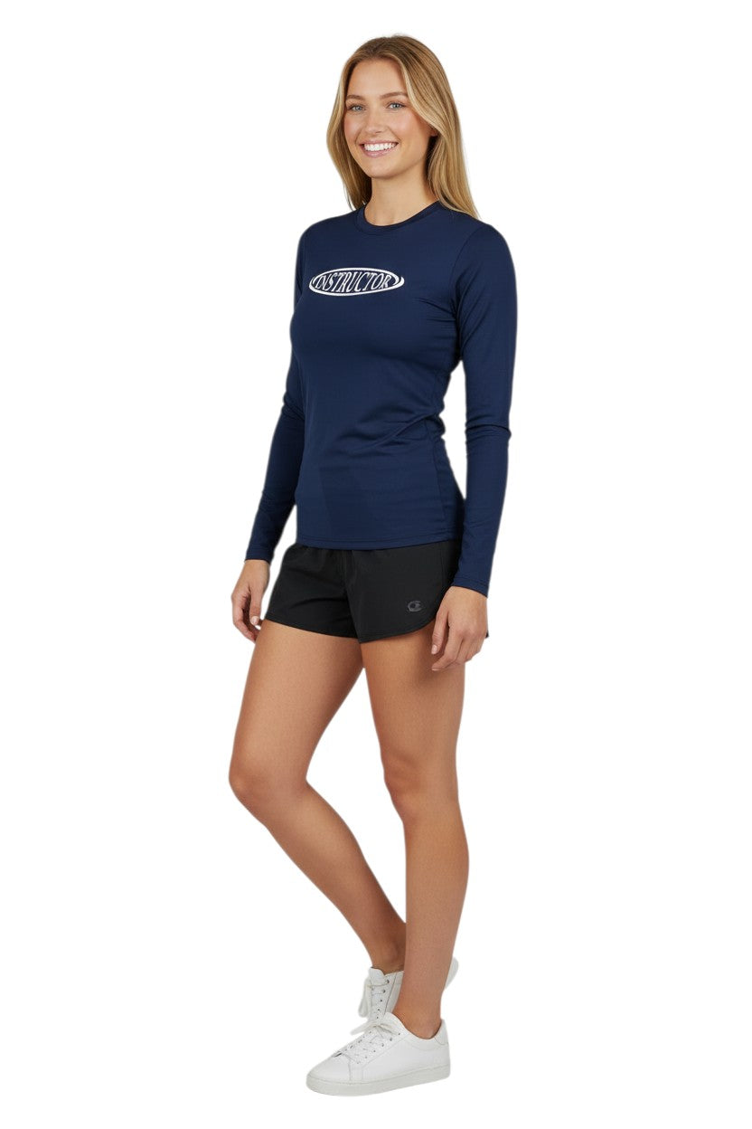 The Lifeguard Store navy blue long sleeve rashguard with white "INSTRUCTOR" graphic on chest. Made of 91% polyester, 9% spandex.