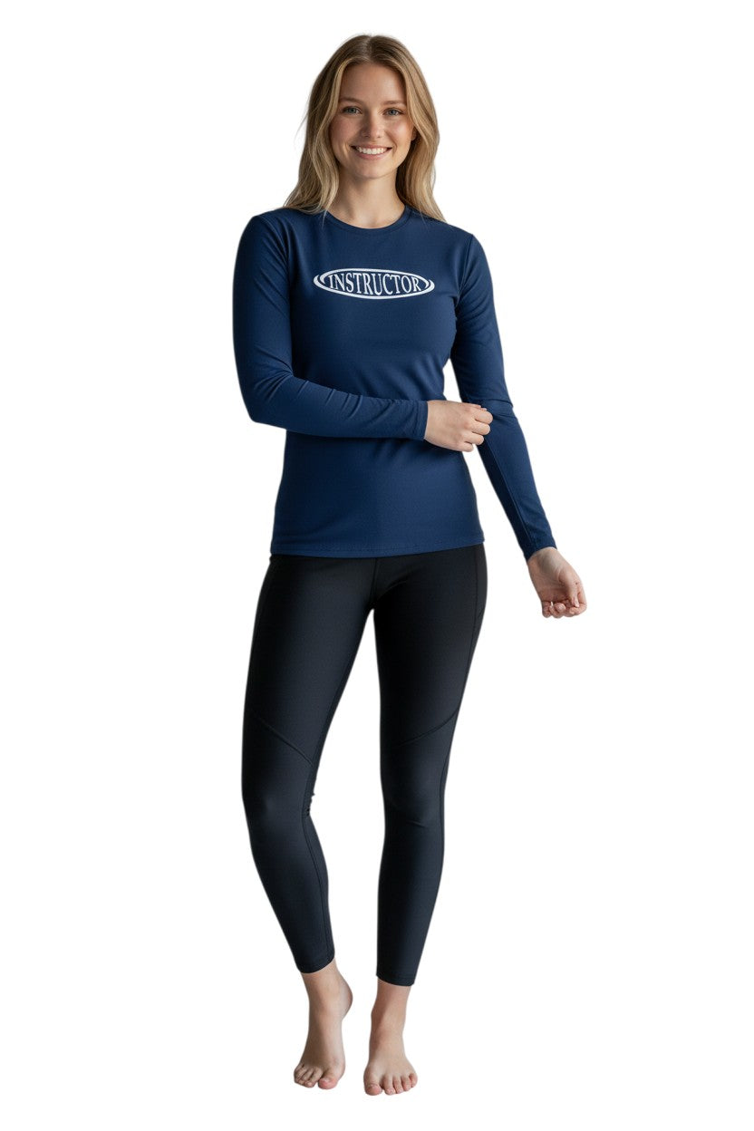 The Lifeguard Store navy blue long sleeve rashguard with white "INSTRUCTOR" graphic on chest. Made of 91% polyester, 9% spandex.