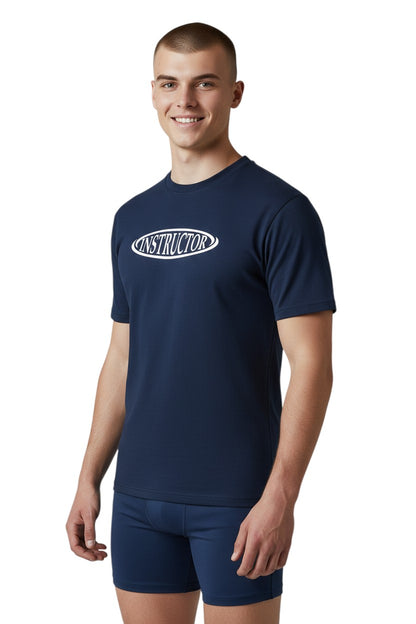 The Lifeguard Store navy blue short sleeve rashguard with white "INSTRUCTOR" text on chest. Made of poly-spandex fabric.
