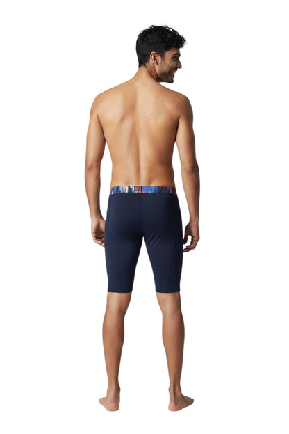 The Lifeguard Store RISE Sandies Shockwave Poly Jammer swimsuit in navy blue with a colorful abstract waistband. Made of polyester and spandex blend.