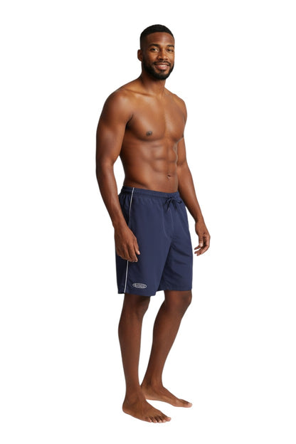 The Lifeguard Store navy blue polyester board shorts with white piping and drawstring waist. Features "MANAGER" logo.