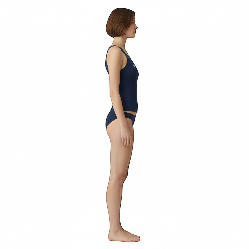 The Lifeguard Store navy blue racer back tankini top with UPF50 protection worn by a model in a side profile view.