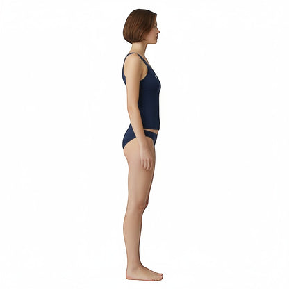 The Lifeguard Store navy blue racer back tankini top with UPF50 protection worn by a model in a side profile view.
