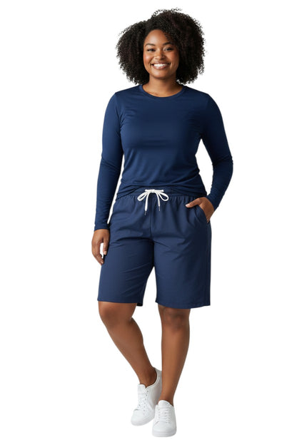 The Lifeguard Store RISE Solid Long Sleeve Crew Neck Rashguard in navy blue, made of polyester and spandex with UPF50+ protection.