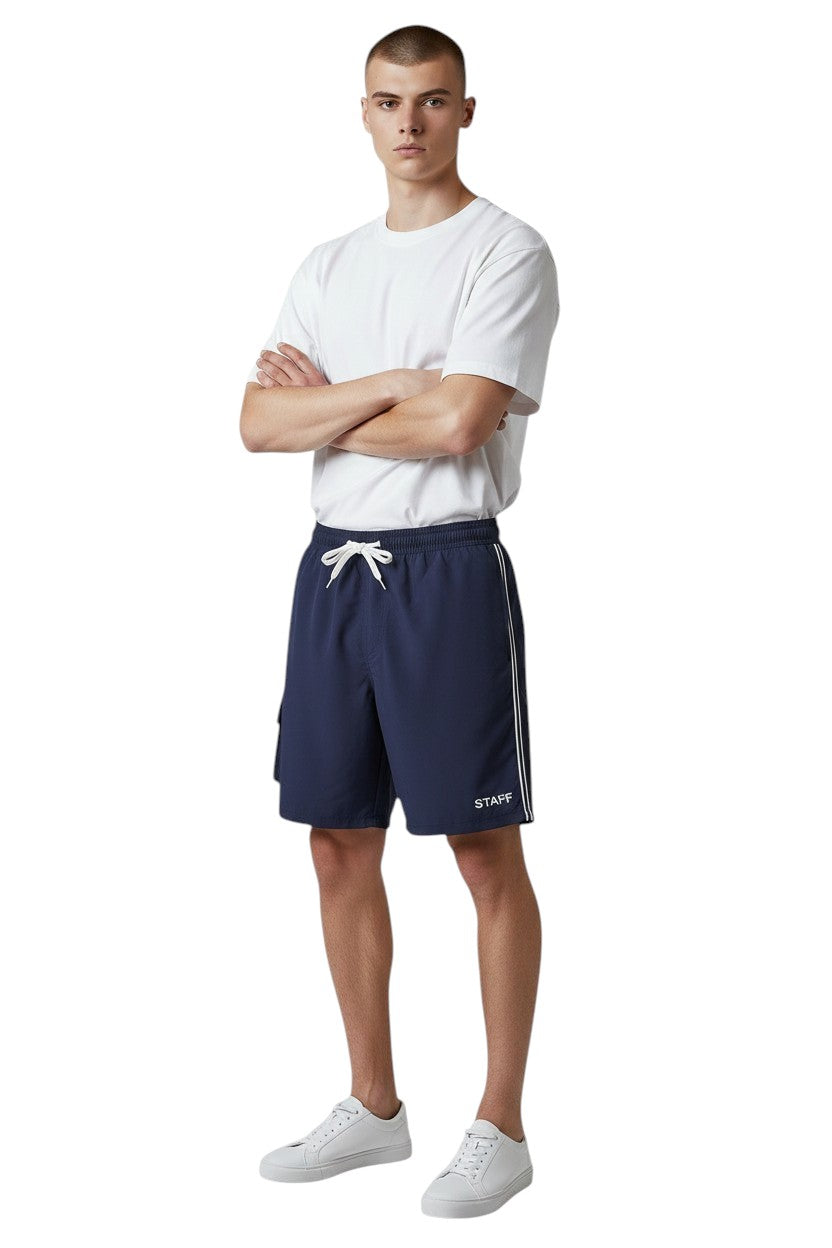 The Lifeguard Store navy blue polyester staff board shorts with liner, elastic waistband, drawstring, and cargo pocket.