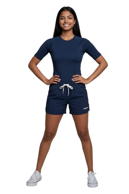 The Lifeguard Store navy blue polyester roll shorts with elastic waistband, drawstring, and "STAFF" logo. Quick-dry fabric.