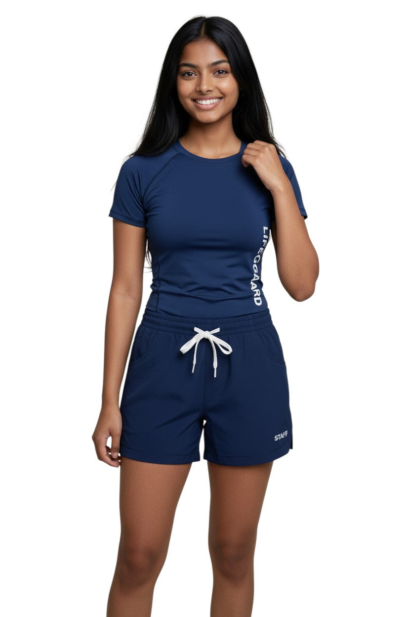 The Lifeguard Store navy blue polyester roll shorts with elastic waistband, drawstring, and "STAFF" print.