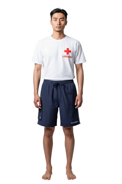 The Lifeguard Store navy blue polyester board shorts with liner, elastic waistband, drawstring, cargo pocket, and "SUPERVISOR" text.