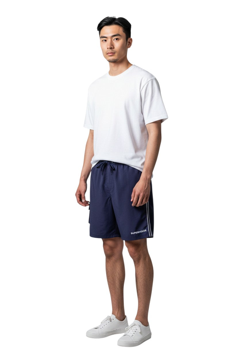 The Lifeguard Store navy blue polyester board shorts with liner, elastic waistband, drawstring, cargo pocket, and "SUPERVISOR" text.