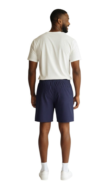 The Lifeguard Store navy blue polyester 5" inseam swim shorts with liner, elastic waistband, drawstring, and pockets.