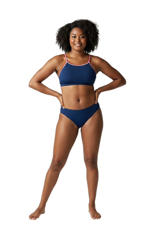 Model wearing The Lifeguard Store tri-color navy blue bikini with red and white trim, made from durable poly stretch.