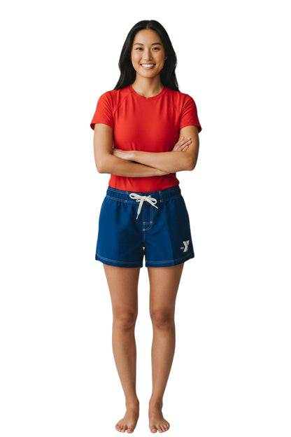 The Lifeguard Store navy blue polyester swim shorts with white drawstring, contrast stitching, and YMCA logo. 5" inseam.
