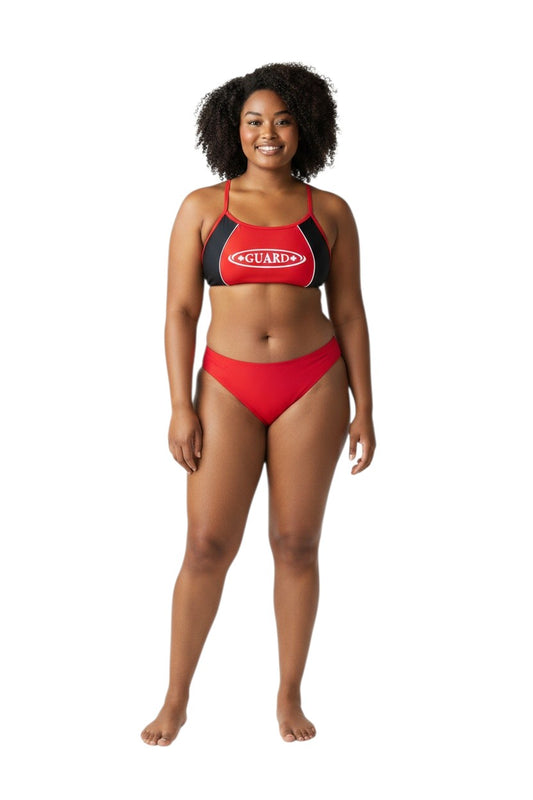 The Lifeguard Store RISE Guard red and black splice bikini with white GUARD logo on a smiling model