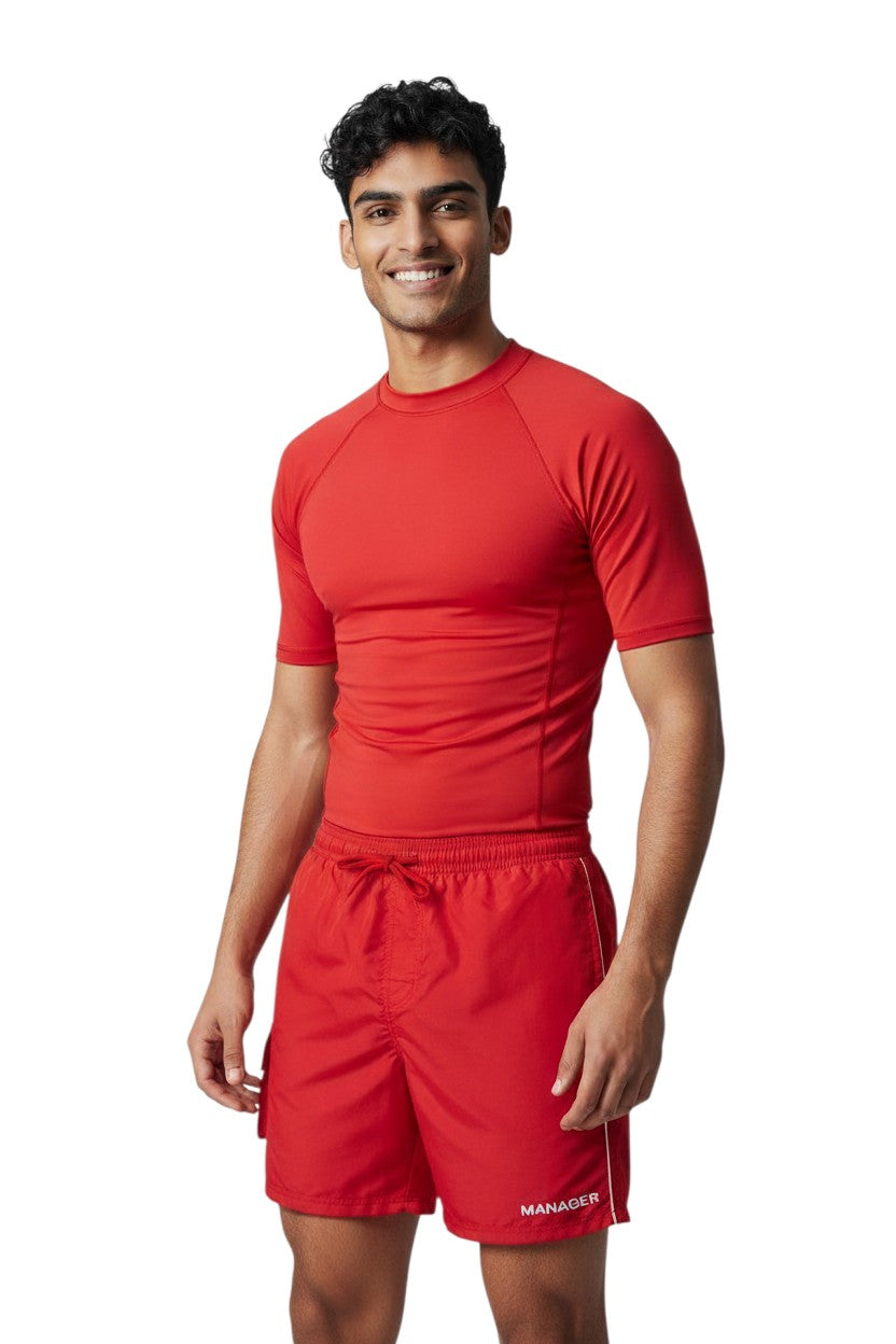 The Lifeguard Store red polyester board shorts with white drawstring and side cargo pocket. Features UPF30+ protection.
