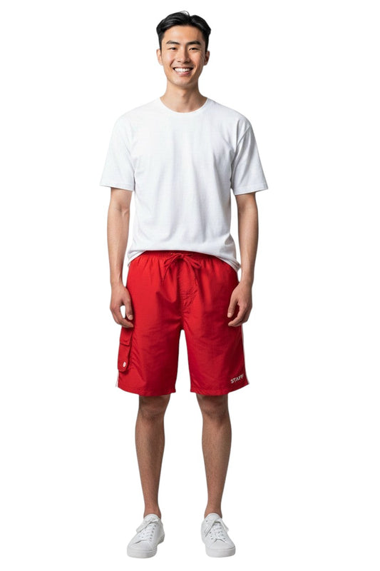 The Lifeguard Store red polyester board shorts with liner, elastic waistband, drawstring, and cargo pocket. Features white side stripe.