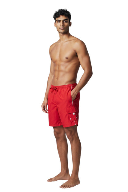 The Lifeguard Store red polyester board shorts with white piping, drawstring, and cargo pocket. UPF30+ protection.