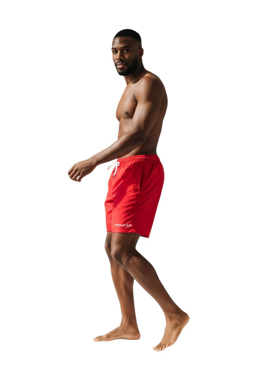 The Lifeguard Store red polyester board shorts with liner, elastic waistband, drawstring, cargo pocket, and "MANAGER" text.