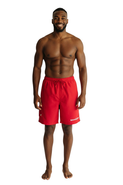 The Lifeguard Store red polyester board shorts with liner, elastic waistband, drawstring, cargo pocket, and "MANAGER" text.