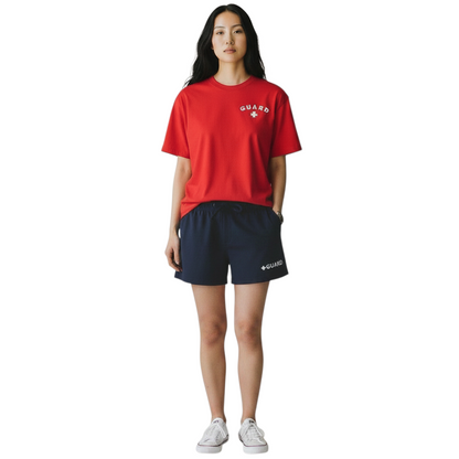 The Lifeguard Store red Dri-Fit short sleeve lifeguard t-shirt with white GUARD logo worn by a female model