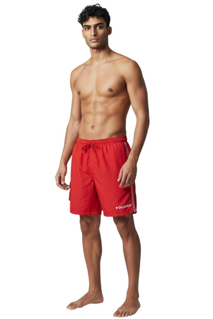 The Lifeguard Store red polyester board shorts with liner, elastic waistband, drawstring, cargo pocket, and "+ GUARD" graphic.