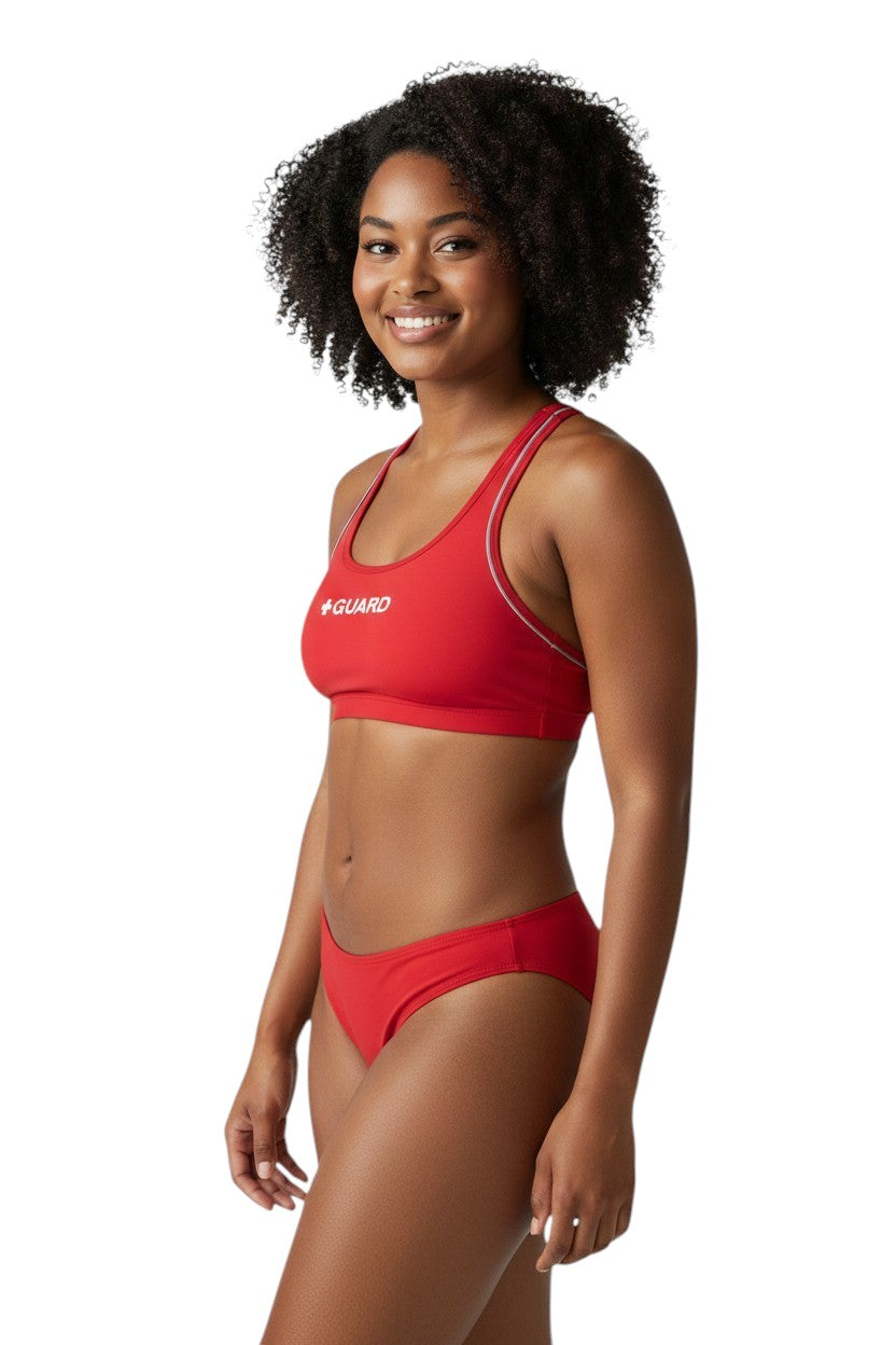 The Lifeguard Store red poly-stretch reversible guard racer back top with navy blue lining and white trim.