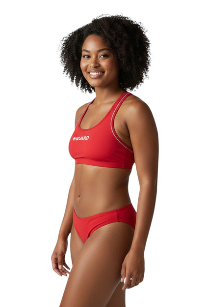 The Lifeguard Store red poly-stretch reversible guard racer back top with navy blue lining and white trim.