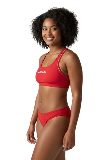 The Lifeguard Store red poly-stretch reversible guard racer back top with navy blue lining and white trim.