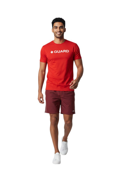 The Lifeguard Store red short sleeve crewneck rashguard with white + GUARD text. Polyester/spandex blend.