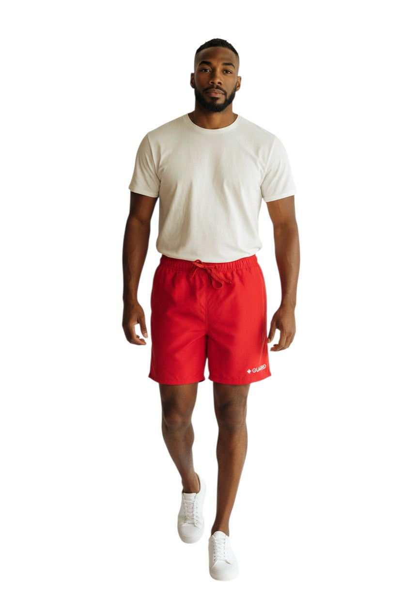 The Lifeguard Store red polyester 5" inseam guard shorts with liner, drawstring waist, and "+ GUARD" graphic.