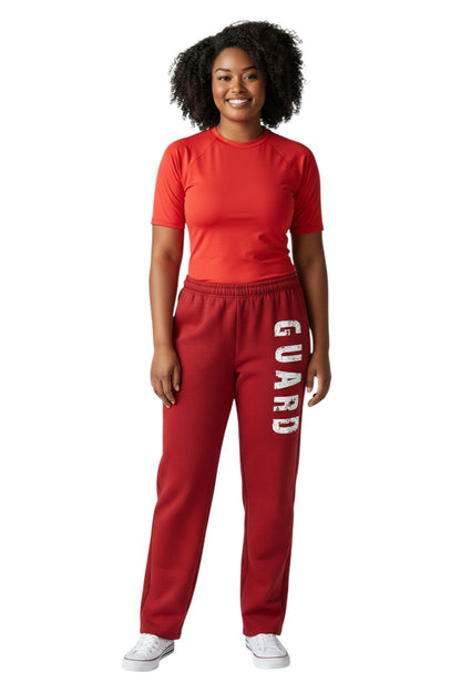 The Lifeguard Store red fleece sweatpants with white distressed "GUARD" logo down the left leg. Cotton/polyester blend.