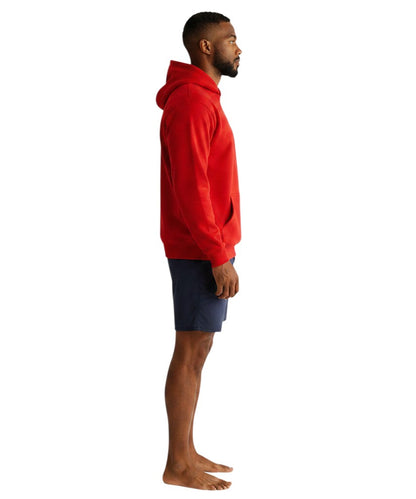 The Lifeguard Store red hooded sweatshirt with front pouch pocket worn by a man in profile view.