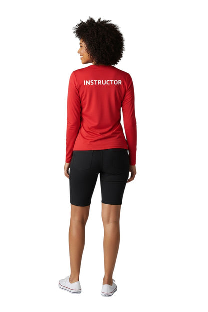 The Lifeguard Store red long sleeve rashguard with "INSTRUCTOR" printed on the back. Made of polyester and spandex for comfort and UPF50+ protection.