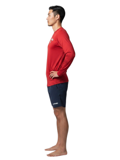 The Lifeguard Store red long sleeve Dri-Fit guard shirt worn by a male model in profile view