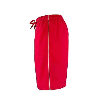 The Lifeguard Store red polyester board shorts with white piping detail and drawstring waist. 7" inseam.