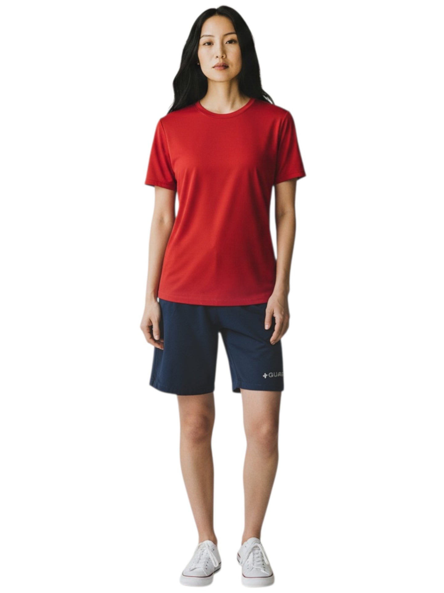 The Lifeguard Store RISE solid red short sleeve crew neck rashguard worn by a model with navy shorts