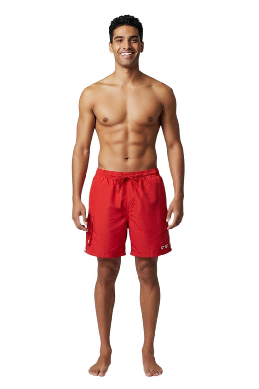 The Lifeguard Store red polyester board shorts with elastic waistband, drawstring, cargo pocket, and STAFF logo.