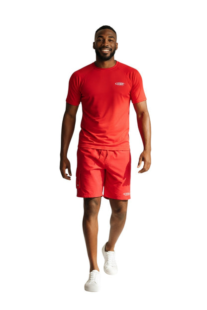 The Lifeguard Store red polyester board shorts with elastic waistband, drawstring, velcro pocket, and staff logo. 7" inseam.