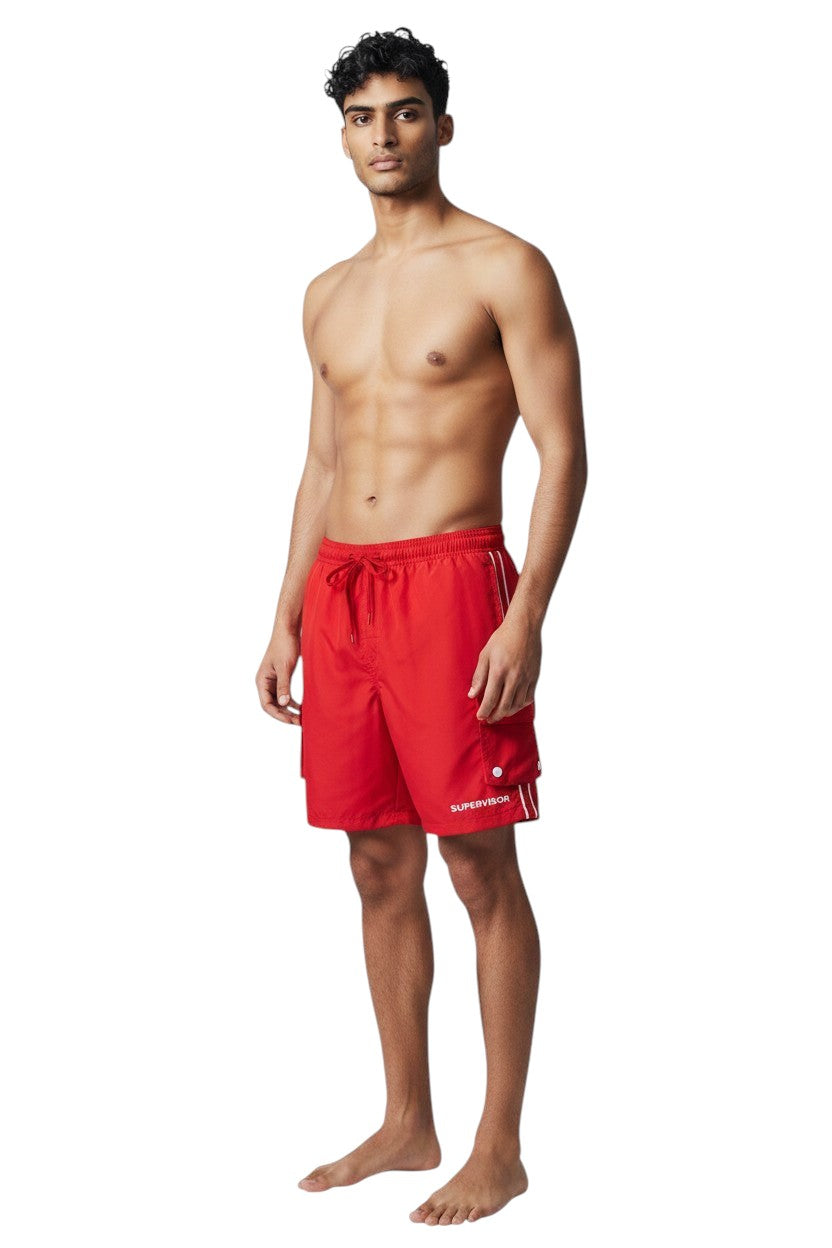 The Lifeguard Store red polyester board shorts with liner, elastic waistband, drawstring, and cargo pocket. Features UPF30+ protection.