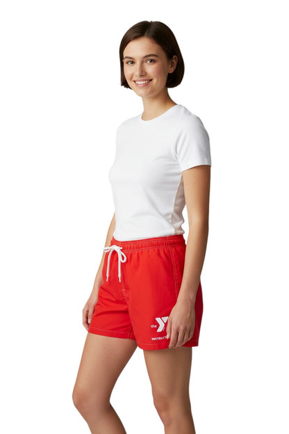 The Lifeguard Store red polyester/spandex board shorts with elastic waistband, side pocket, and YMCA Instructor logo.