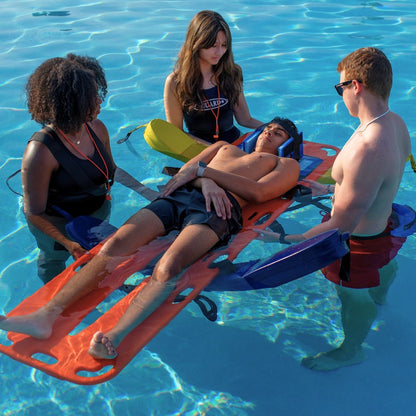 The Lifeguard Store rescue board with a person secured and lifeguards assisting in a pool.