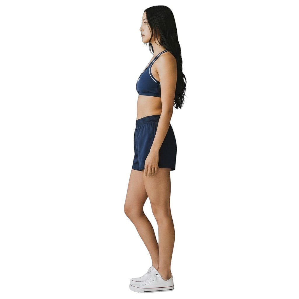 The Lifeguard Store Kiefer reversible navy blue racer back guard top worn by a model in profile view.