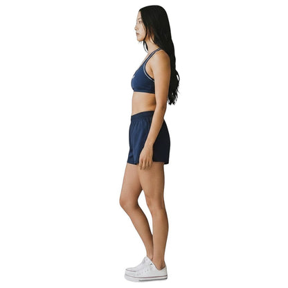 The Lifeguard Store Kiefer reversible navy blue racer back guard top worn by a model in profile view.