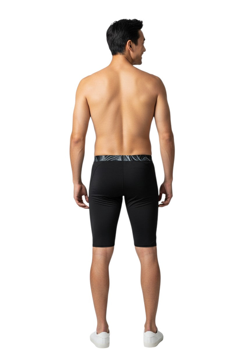 The Lifeguard Store RISE Sandies Helix Poly Jammer swimsuit in black with a white and black abstract pattern waistband. Made of 91% Polyester/9% Spandex.