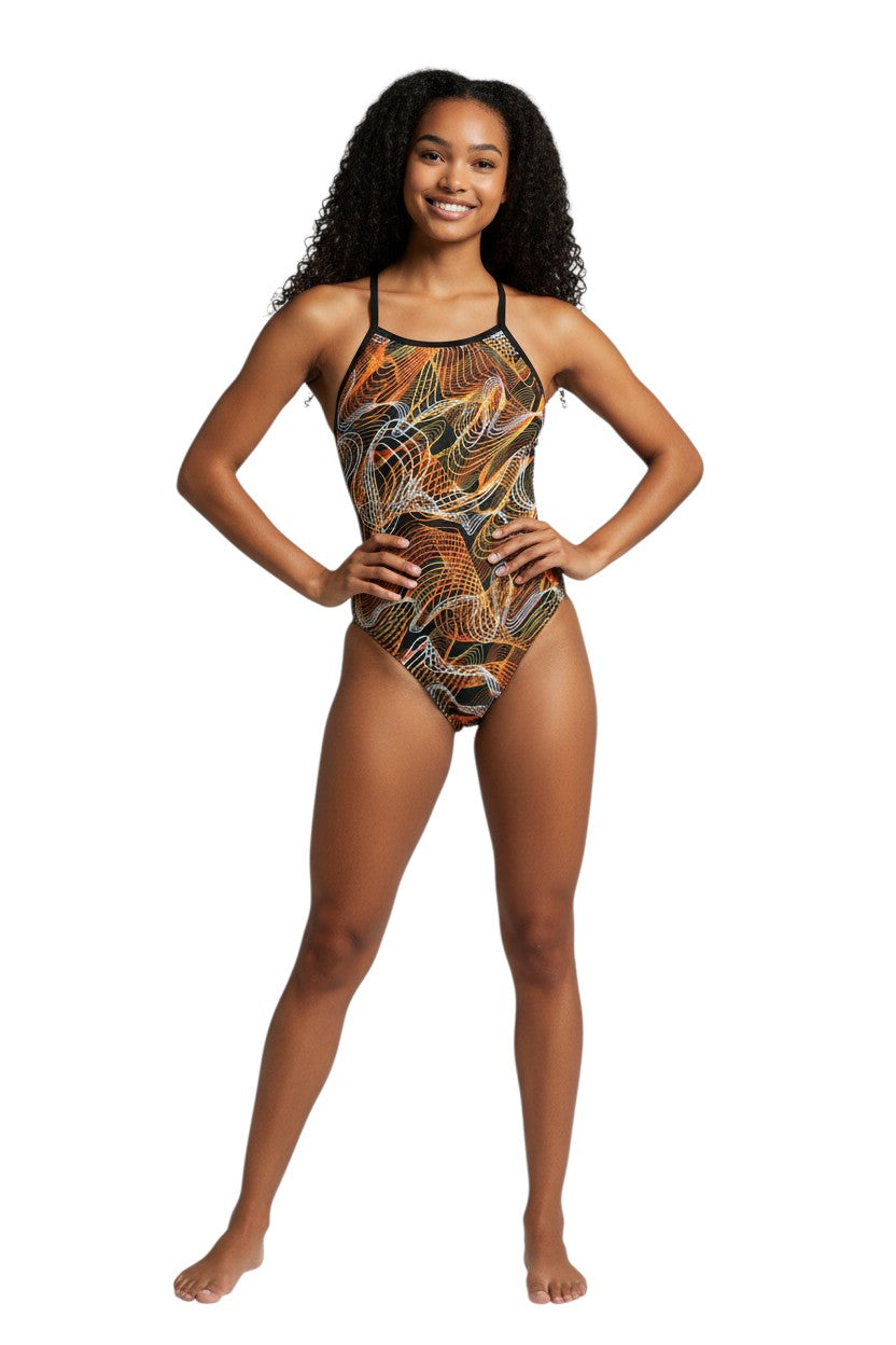 The Lifeguard Store RISE Sandies Female Helix swimsuit in black with orange and white abstract wave pattern. Polyester/Spandex blend.
