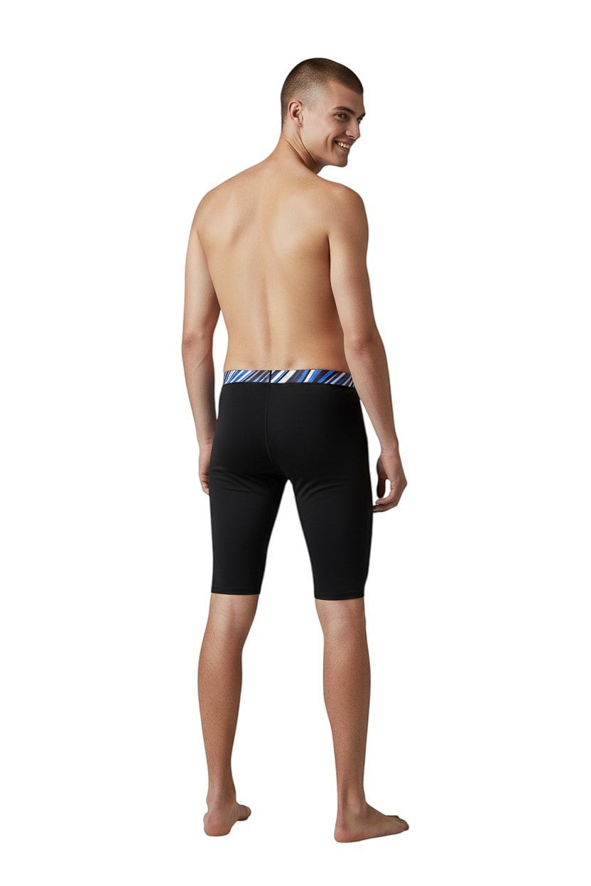 The Lifeguard Store RISE Sandies black poly jammer swimsuit with a blue, white, and black striped waistband.