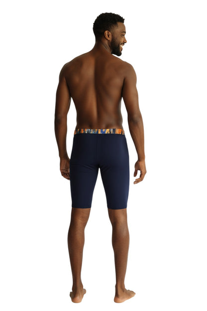 The Lifeguard Store RISE Sandies Shockwave Poly Jammer swimsuit in navy with a colorful abstract waistband. Made of polyester and spandex blend.